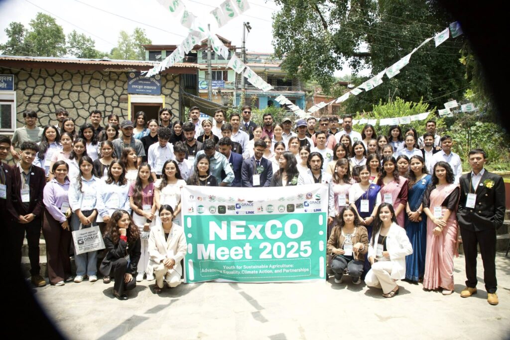 A large group of people posing for a photo at the NExCO Meet 2025 event.